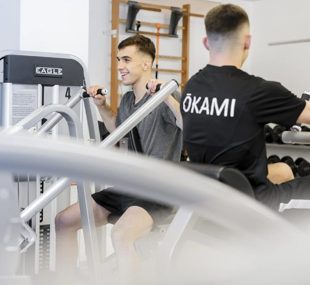 Entraînement en salle de sport, deux hommes utilisant des machines de musculation